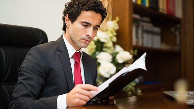 Professional man in office looking at document