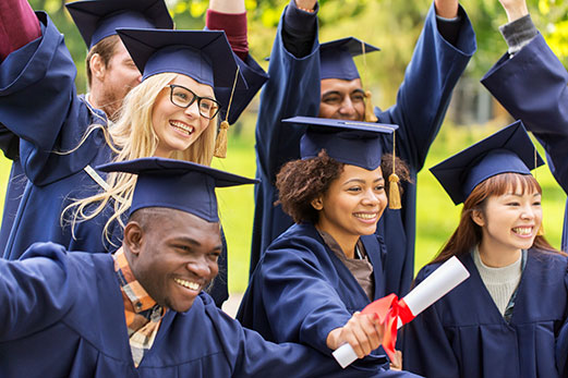 Happy young adults in cap and gown holding diploma