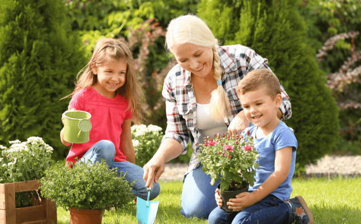 Caucasian grandmother in garden with two grandchildren