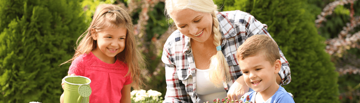 Caucasian grandmother in garden with two grandchildren