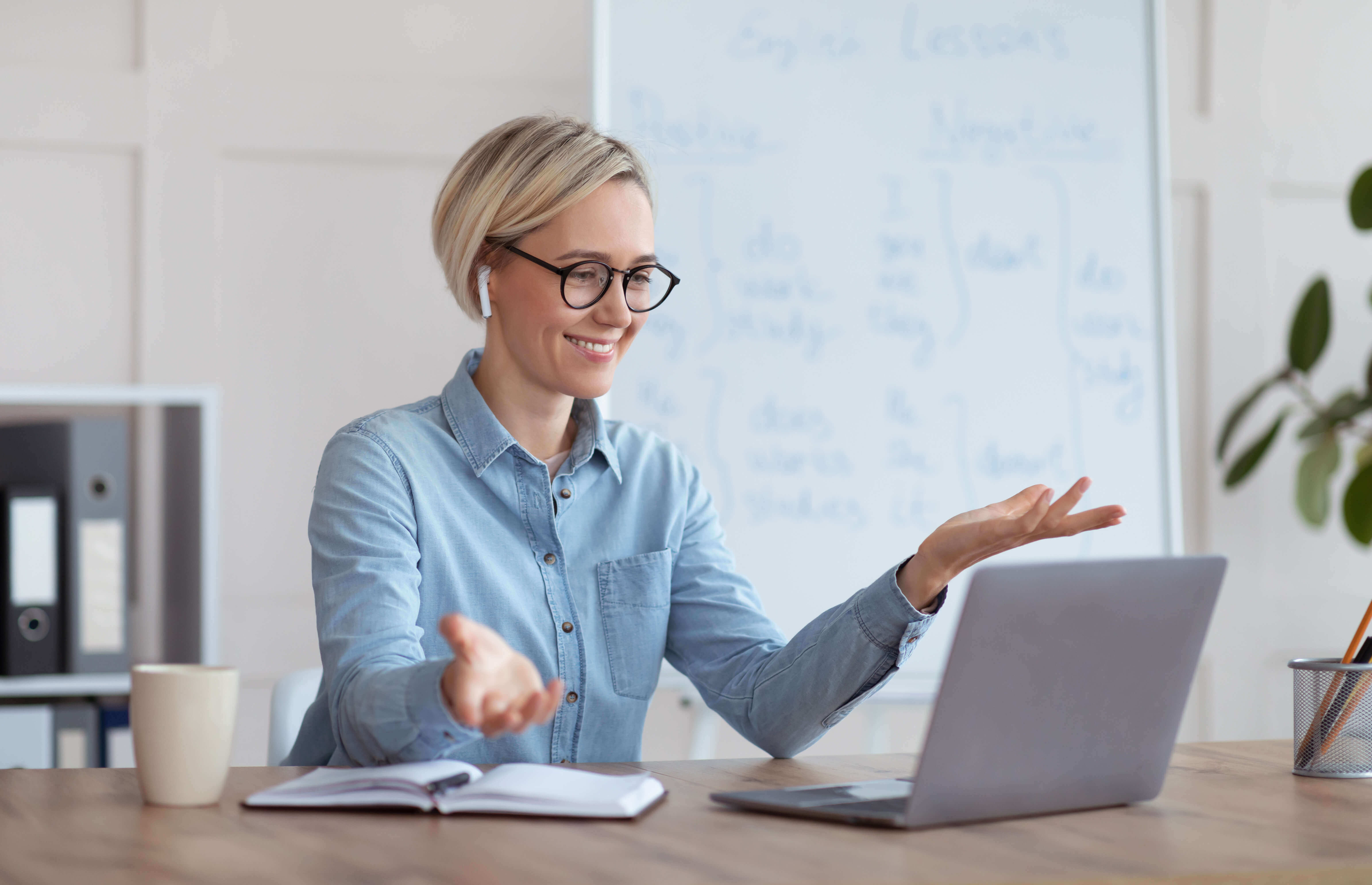 Smiling Caucasian woman looking at laptop